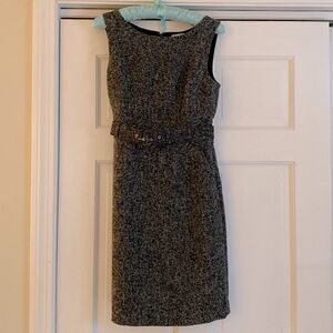 Sleeveless gray dress with belt.